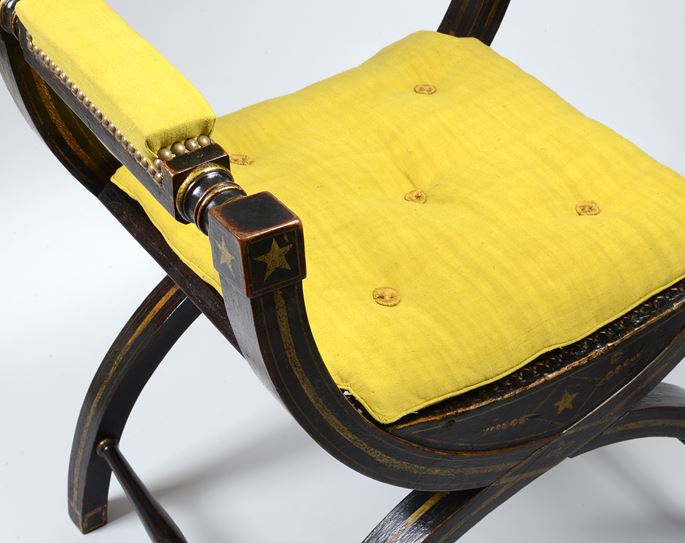 An impressive ebonised and gilt decorated X-framed armchair | MasterArt